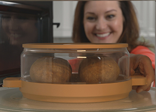 Potatoes cook inside Yummy Can Potatoes™ inside the microwave